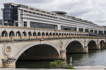Fototapeta na wymiar Bridge of Bercy (Pont de Bercy) is a bridge over the Seine in Paris. The Pont de Bercy, stone suspension bridge opened in 1864. Paris. France.