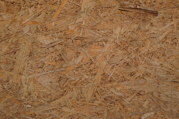 Closeup of OSB (oriented strand board) construction material. Rough texture background.