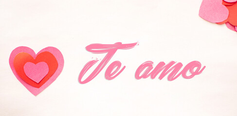 Imagen de corazones de colores rosas recortado en fondo blanco con la frase te amo 