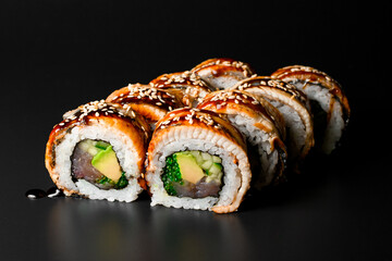 delicious Philadelphia sushi rolls with rice, salmon, eel, cucumber, tobiko caviar, cheese, soya sauce and sesame