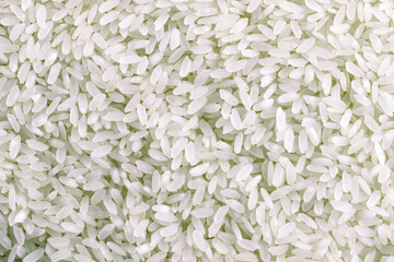 Long white rice jasmine background. Organic cereal grains pattern. Top view, close-up. Healthy food concept.