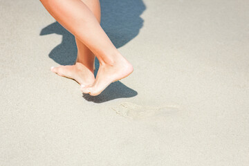 Fototapeta na wymiar A Feet and footprints by the seashore in nature travel vacation background