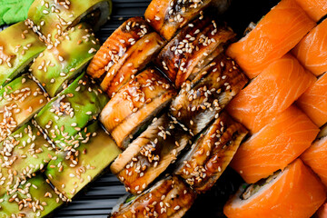 Close-up top view on set of Philadelphia and Green dragon sushi rolls. © fesenko