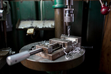 Part machining with drilling machine