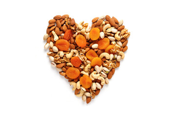 Dried fruits and nuts, laid out in the shape of a heart on white background . Concept of the Jewish holiday Tu Bishvat. Copy space