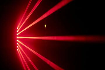 Fototapeta Bright red neon laser lights illuminate the darkness creating lines and triangle shapes in sci-fi effect. obraz