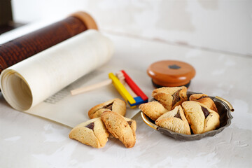 Scroll of Esther and haman's ears cookies. Concept Jewish holiday Purim.