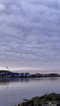 Verticel Timelapse of a small marina in industry on the coast of western Norway