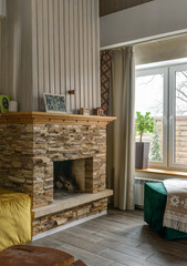 Large stone fireplace in a stylish modern rustic house with decor