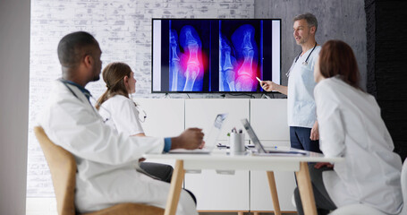 Doctors And Radiologists Discussing X-ray Images