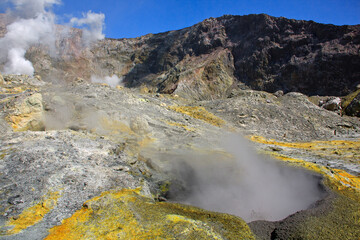 Hot steam coming out of a small volcanic crater just beside the main crater of Whakaari, White Island Volcano in new Zealand