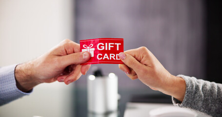 Hand Giving Gift Voucher Card