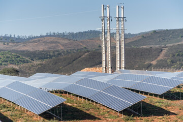 Aerial. Station's solar panels cover fields of Portuguese hills to generate clean, ecological...