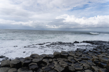 Fototapeta na wymiar Giant's Causeway, area of interlocking basalt columns in Northern Ireland. Result of an ancient volcanic fissure eruption. The Causeway Coast natural wonder is managed by the National Trust.