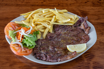 A traditional Portuguese dish of roasted black pig meat and fried potatoes. Bife de vazia