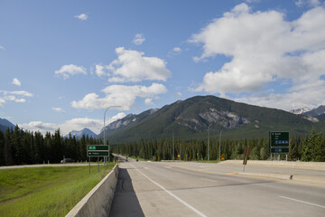  Highway in mountains Trans Canada Highway with a perfect asphalt at sunrise in summer.  in Banff National Park, Alberta, Canada.  Travel background.