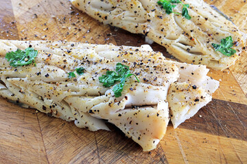 flaky white cod fillets seasoned with salt and black pepper.
