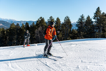 Fototapeta na wymiar Two boys standing on a ski slope full of snow.