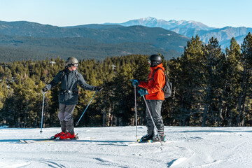 Two boys talking on a ski slope.