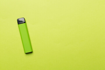 Disposable electronic cigarette on color background, top view