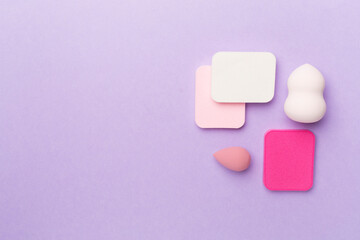 Beauty blenders on color background, top view