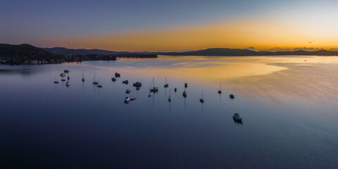 Aerial sunrise waterscape over the bay with boats