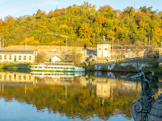 Fototapeta premium Colors of autumn Prague. Picturesque autumn colors on the embankment by the Vltava river, Prague, Czech Republic