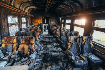 Train after fire. Burnt interior of passenger carriage. Consequences of fire or war