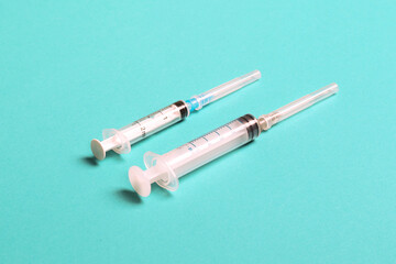 Top view of different syringes for injection on colorful background. Medical equipment concept with copy space