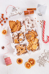 Obraz na płótnie Canvas Top view of unpacked christmas present with sweets on a white textured surface, close-up. Christmas celebration concept