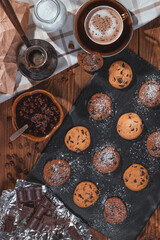 Cookies with chocolate and coffee on a wooden table, flat lay, top view