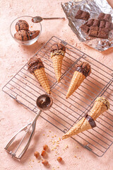 Chocolate ice cream on a metal rack with scoop from stainless steel, flat lay, top view