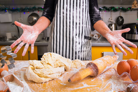 An inept inexperienced housewife, a woman cook, does not know how to knead the dough correctly for Christmas gingerbread, asks for advice