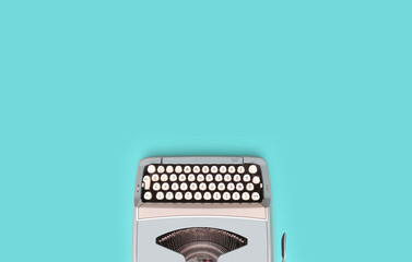 Overhead top view of a vintage aqua blue typewriter against a turquoise background