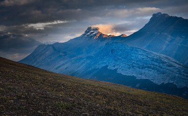 Light and storm clouds on mountain peak