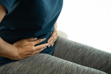 close up woman has stomachache or menstrual on white background, medicine and healthy concept