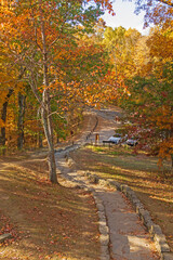 Fototapeta na wymiar Rustic Path in a Forested Park in the Fall