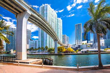 Miami downtown skyline and futuristic mover train above Miami river view