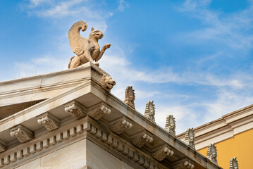 Detailed view of the decoration of the top right corner of the Zappeion Hall neoclassical building in Athens, Greece. A Griffin ontop of the pediment, the gutter has the shape of a lion's head