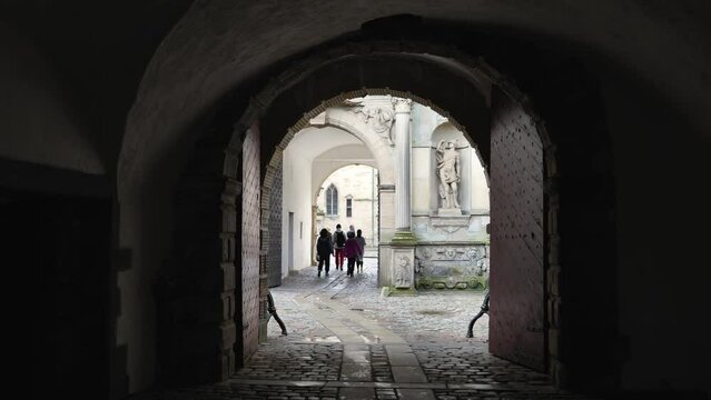 Group of tourist enter arch gate of Kronborg Slot castle. 
