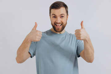 Portrait of a modern bearded middle-aged man in a blue t-shirt showing good emotions on a white background