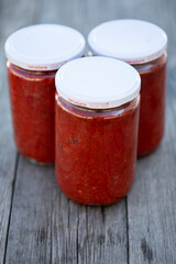 Traditional turkish chili pepper and tomato paste in bowl or spoon with dried peppers and fresh tomatoes on table