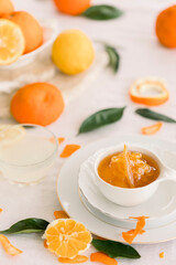 Fresh bitter orange marmalade with ripe fruit offered as closeup on a rustic black board with copy space