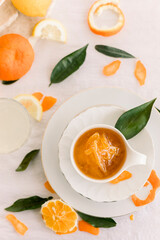 Fresh bitter orange marmalade with ripe fruit offered as closeup on a rustic black board with copy space