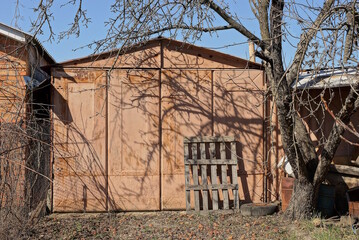 one old brown rusty iron garage with closed gates on the street
