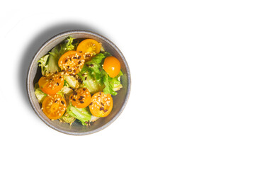 Healthy fresh salad of vegetable, tomato, spinach, arugula in plate on white background. Food background for menu, recipe. Top view.