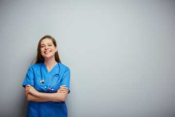 Nurse in blue medical suit, portrait with copy space on wall.