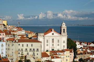 Fototapeta premium Historic Church above Lisbon Rooftops and the Tagus River, Portugal