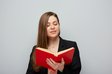 Portrait of smiling girl student or woman teacher reading book.