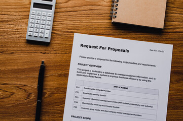 There is dummy documents that created for the photo shoot on the desk about Request For Proposal.